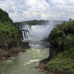 Cataratas del Iguazú: la Garganta del Diablo cae al fondo envuelta en bruma blanca, entre acantilados cubiertos de selva verde y un río de aguas verdosas